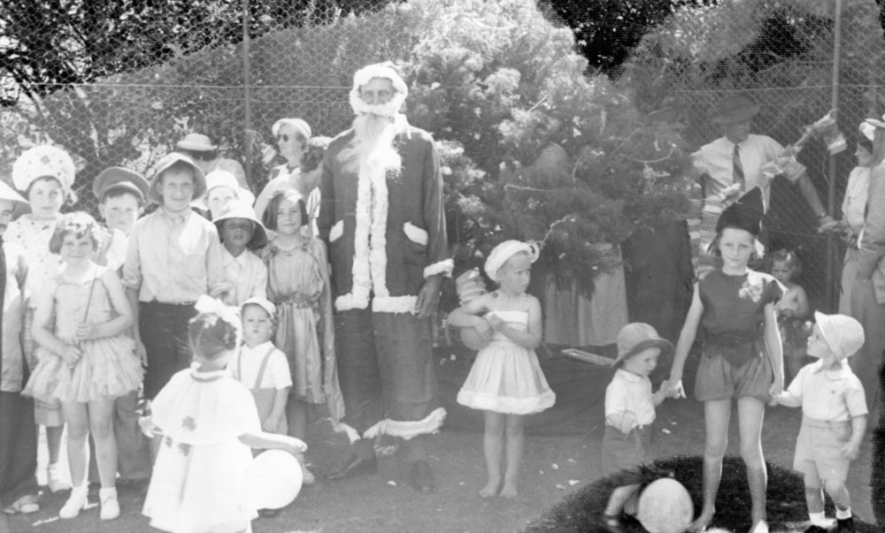 Man Dressed as Father Christmas Surrounded By Children
