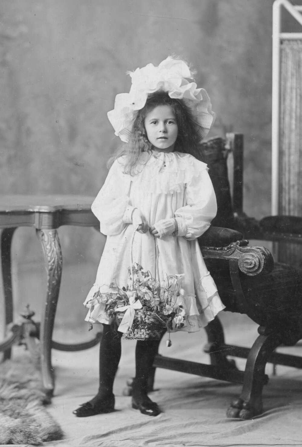 Studio Portrait of Girl with Flower Basket