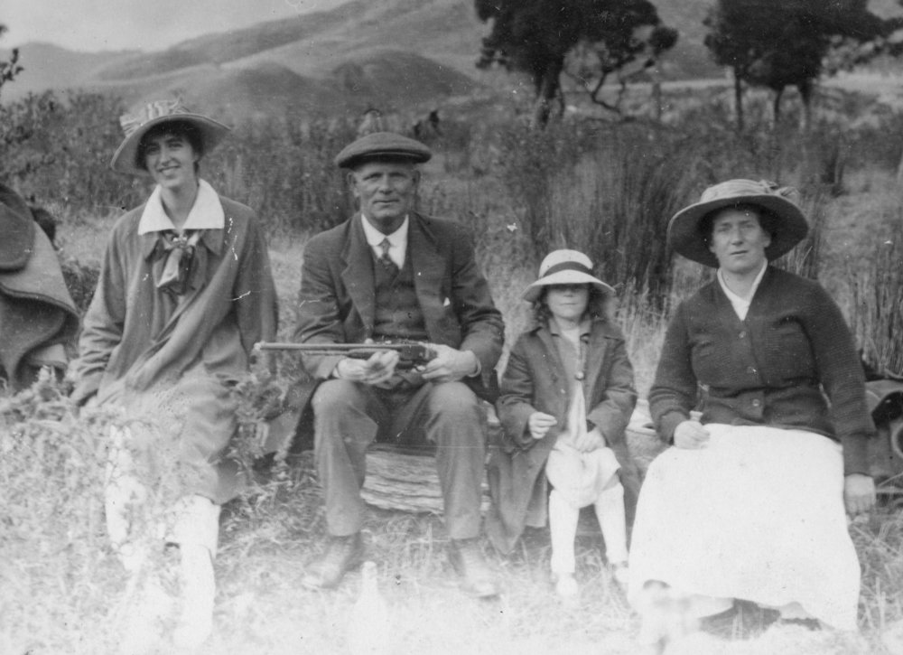 Outdoor Family Portrait with Man Holding Gun
