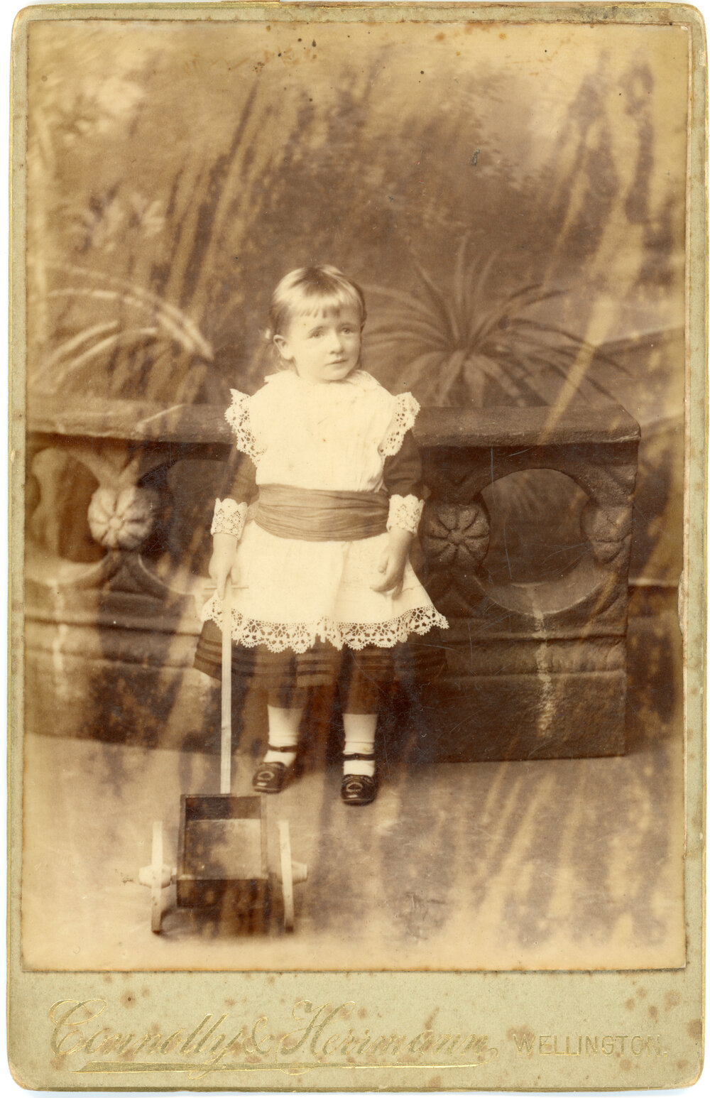 Studio Portrait of Young Child with Push Toy