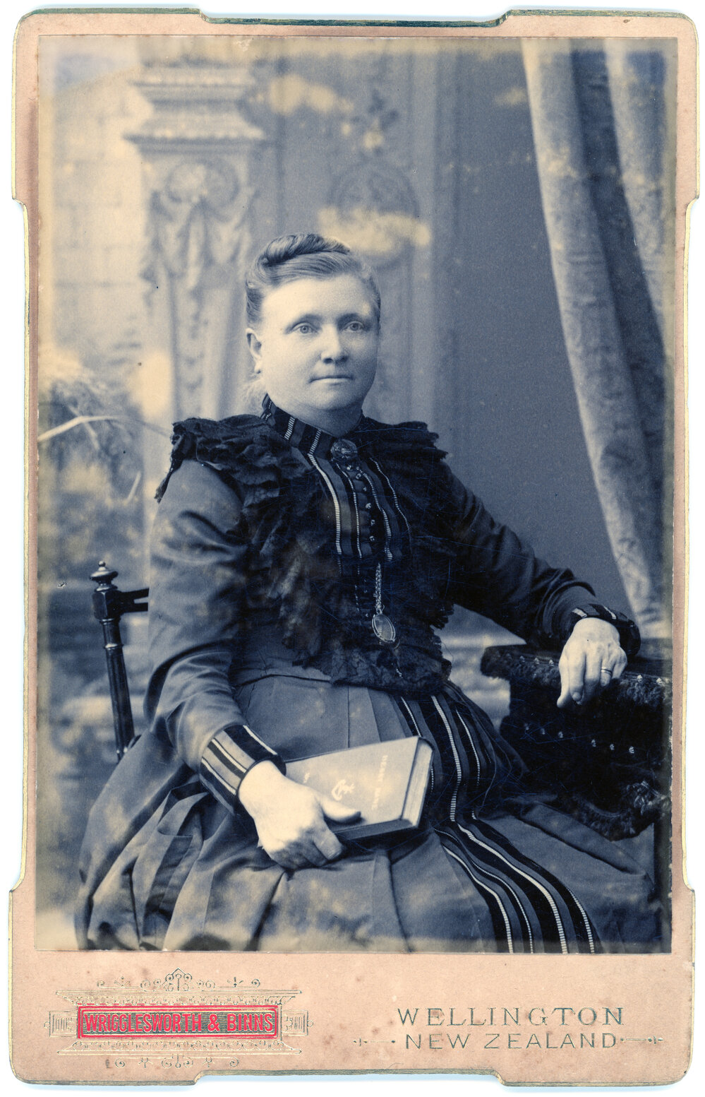 Studio Portrait of a Woman Holding Book