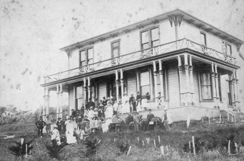 Large Group Photo with Two Storey House