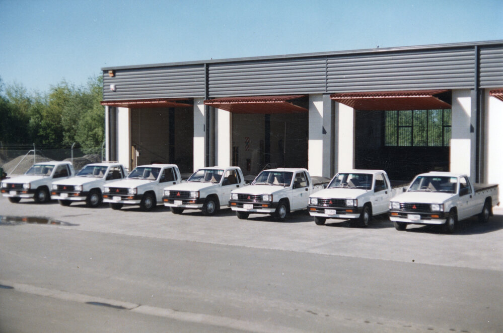Mitsubishi Utes in Front of Garage