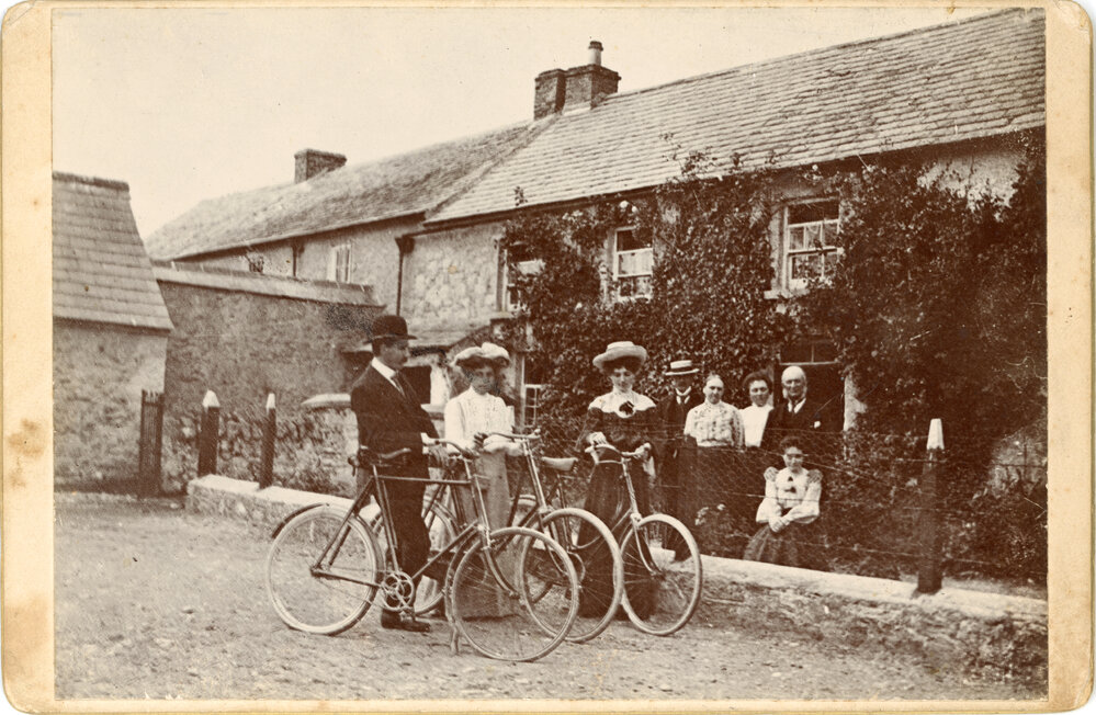 Family Pose with Bicycles In Front of House