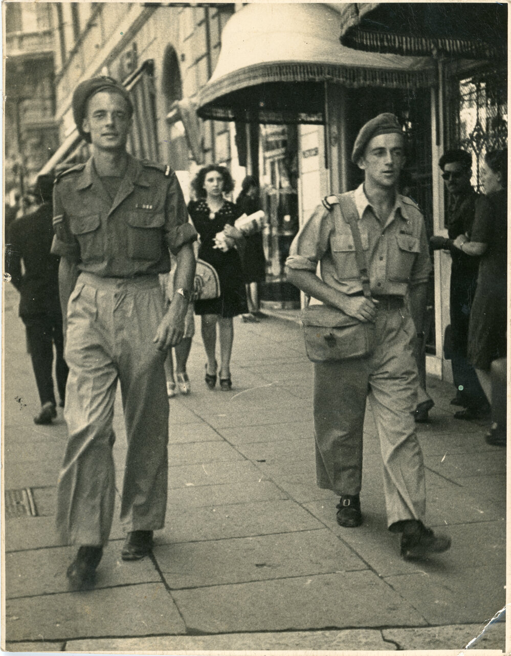 Soldiers Walk Along City Street