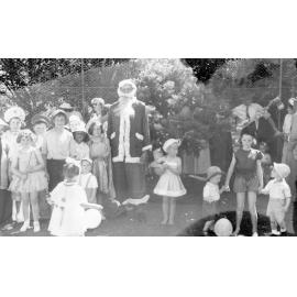 Man Dressed as Father Christmas Surrounded By Children