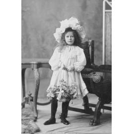 Studio Portrait of Girl with Flower Basket