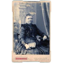 Studio Portrait of a Woman Holding Book