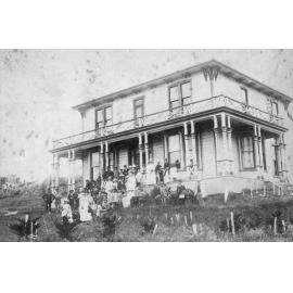 Large Group Photo with Two Storey House