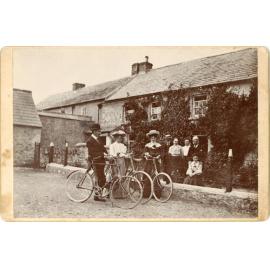Family Pose with Bicycles In Front of House