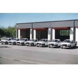 Mitsubishi Utes in Front of Garage