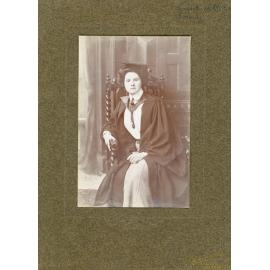 Studio Portrait of Young Woman in Cap and Gown