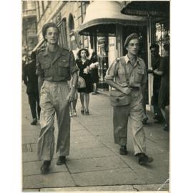 Soldiers Walk Along City Street