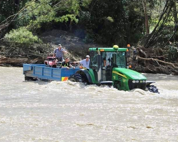 Matt Fryer helping transport people and machinery across a flooded river after Cyclone Gabrielle.